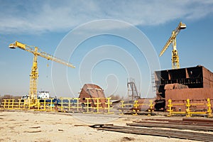 Ship and monumental crane in the shipyard
