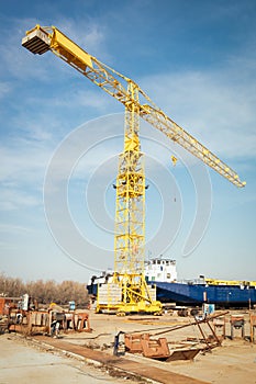 Ship and monumental crane in the shipyard