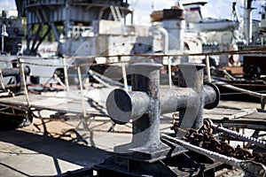 The ship is moored to a dock ladder rope chain