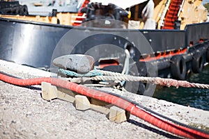 The ship is moored to a dock ladder rope chain