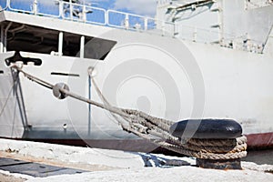 The ship is moored to a dock ladder rope chain