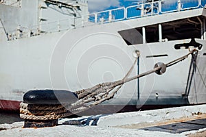 The ship is moored to a dock ladder rope chain