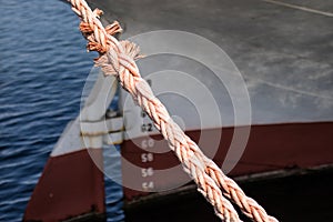 Ship mooring rope on the port wharf. Harbor bollard for large na