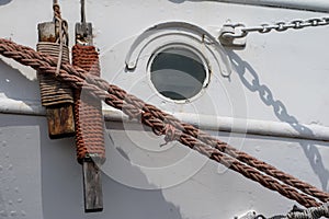 Ship mooring rope on the port wharf. Harbor bollard for large na