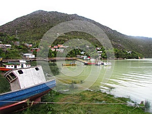 Ship and nature in Caleta Tortel, Carretera Austral, Patagonia, Chile. Village surrounded for mountains