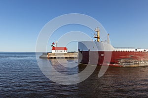 Ship Passing A Lighthouse On Lake Superior