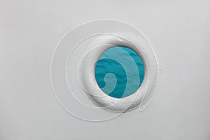 Ship porthole on white wall