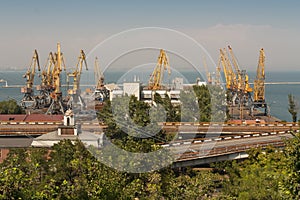 Ship-repair yard. Industrial zone of sea cargo port with grain dryers, containers, cranes and storehouses photo