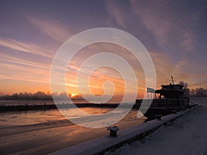 Ship in river in sunrise colors, Lithuania