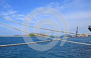Ship rope against blue water sea texture background