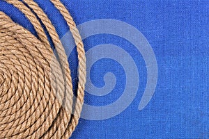 Ship rope on blue background, top view with copy space