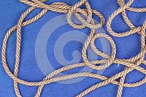 Ship rope on blue background, top view with copy space