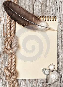 Ship rope, shells, feather, notebook and old wood