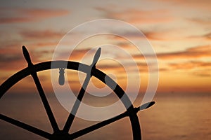 Ship rudder with sunset on background