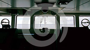 Silhouette of the ship`s bridge with sea and sky infront of the windows.