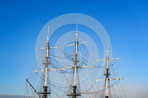 Ship`s mast against a backdrop of blue sky