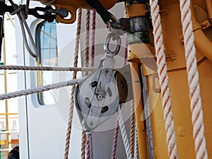 The ship`s rope hangs on the mast of a sailing ship.  A Bay of nylon rope on the deck of a sailboat.