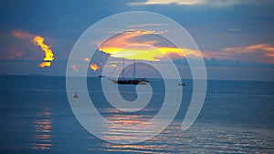 Ship sails on a background of beautiful sunset.