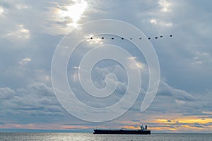 the ship sails on the sea against the backdrop of a beautiful cloudy sky.