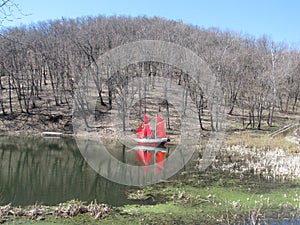 Ship with scarlet sails on the lake spring forest
