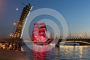 A ship with scarlet sails passes under the Troitsky Bridge.