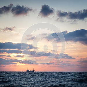 Ship in the sea at sunset