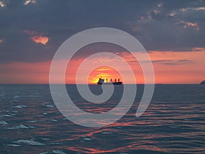 Ship at sea during sunset