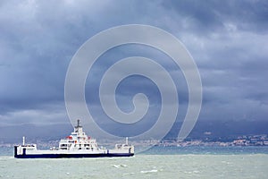 Ship at sea under dramatic clouds Sicily Italy Europe