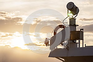 Ship searchlight and lifeline in evening sunlight...