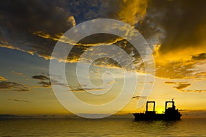 Ship Silhouette with Stormy Clouds at Sunset