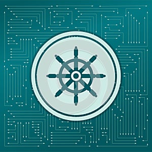 Ship steering wheel icon on a green background, with arrows in different directions. It appears on the electronic board.
