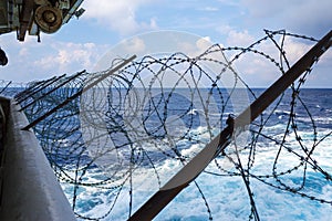 Ship stern fortified with razor wire. Anti piracy protection mounted before entering (HRA) Piracy High Risk Areas