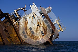 A ship sunk in the sea, carrying smuggling and flying on the stones. rusty frame.