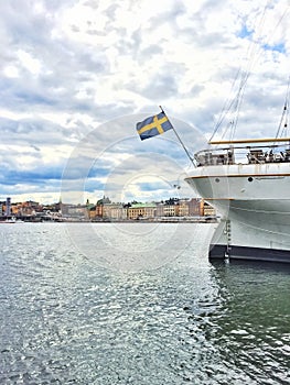 Ship with Swedish flag and view over Gamla Stan, Stockholm