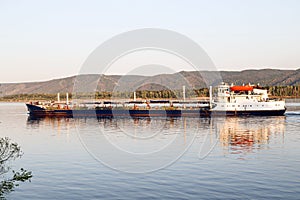 the ship tanker on the background of high mountain