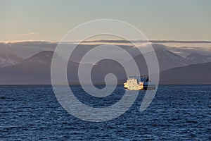 Ship to visit fjords in Norway in polar day, midnight sun. A mystical fjord with dark clouds in Norway with mountains and fog