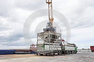 Ship unloading grain on truck