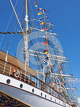 Ship, water and harbor at sea to coast guard with landscape, blue sky and nautical flags for emergency sailing. Vessel