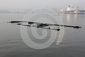 Ship wrakage lagos port and ships at anchor at the background or misty day