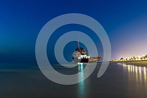 Ship Wreck along the Umm Al Quwain Coast in UAE. A stranded or abandoned vessel on the beach.