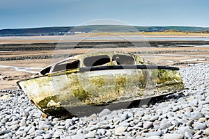 Ship wreck of an old boat washed up on a rocky beach