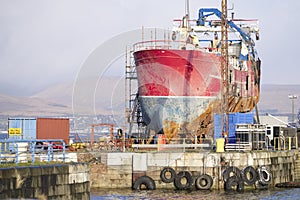 Ship wreck vessel and rescue lift crane at port dock for repair of capsized boat