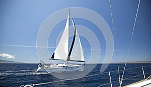 Ship yachts with white sails in the open Sea.