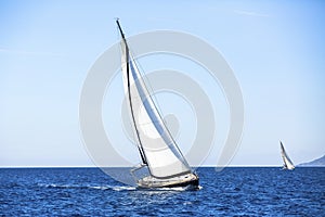 Ship yachts with white sails in the open Sea. Luxury boats.