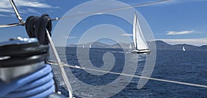 Ship yachts with white sails in the open Sea. Luxury boats.