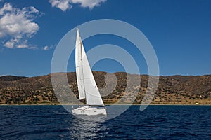 Ship yachts with white sails in the open Sea.