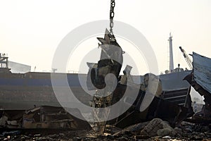 Shipbreaking Yard in Darukhana, Mumbai, India Ã¢â¬â INS Vikrant dismantling with scrap metal & workers in background photo