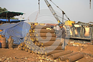 Shipbreaking Yard in Darukhana, Mumbai, India Ã¢â¬â INS Vikrant dismantling with scrap metal & workers in background photo