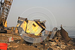 Shipbreaking Yard in Darukhana, Mumbai, India Ã¢â¬â INS Vikrant dismantling with scrap metal & workers in background photo