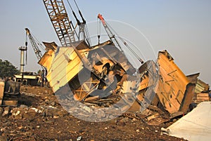 Shipbreaking Yard in Darukhana, Mumbai, India Ã¢â¬â INS Vikrant dismantling with scrap metal & workers in background photo